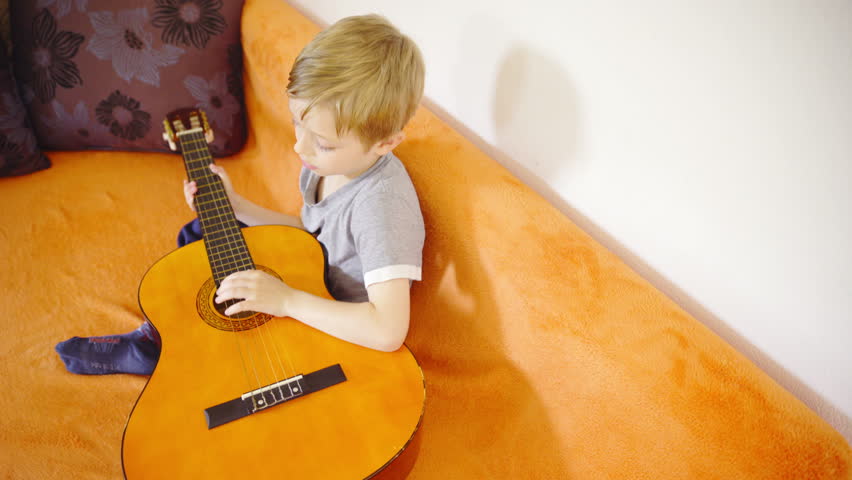 Child Repair Stylish Hair Before Play On Guitar 4K. Young ...