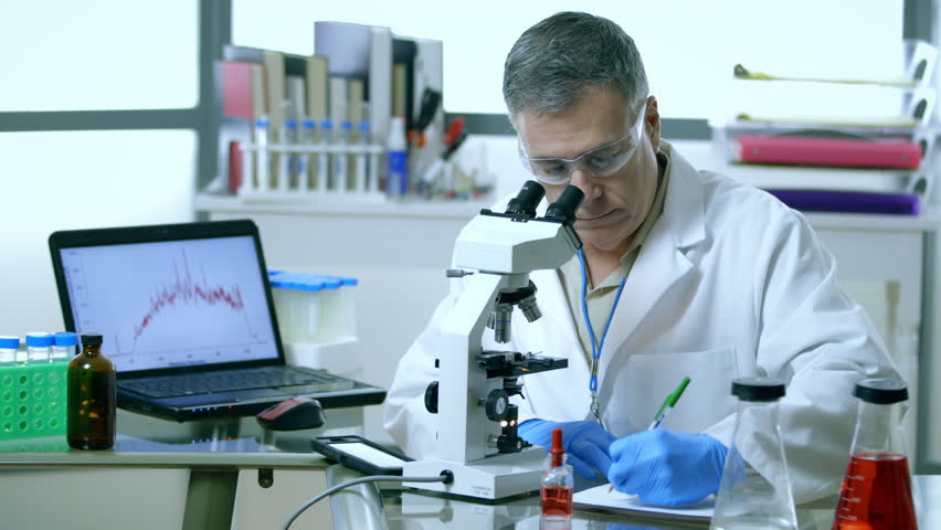 A Microscope And Computer Being Used By This Scientist In His 