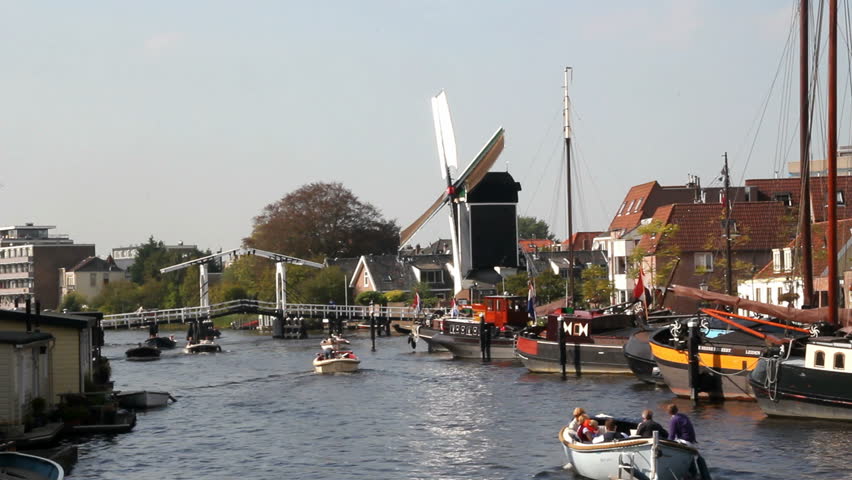LEIDEN, HOLLAND - SEPTEMBER 24: People sail in boats in a canal on September 24, 2011, Leiden, Holland. Leiden is the second largest 17th century town centre in the Netherlands. - HD stock video clip