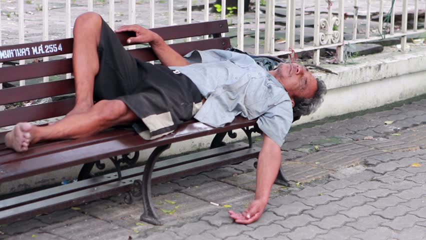 BANGKOK 19 OCTOBER 2011 Homeless Man Sleeps On Bench Stock Footage