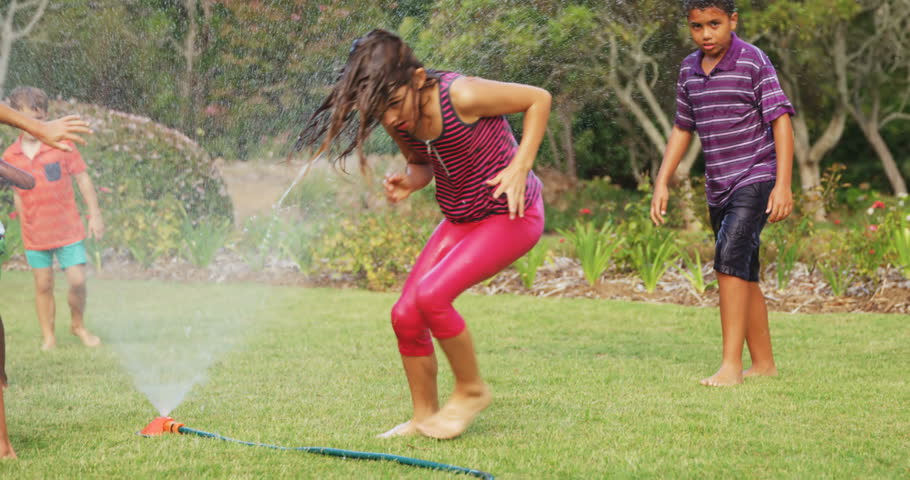 playing in sprinkler