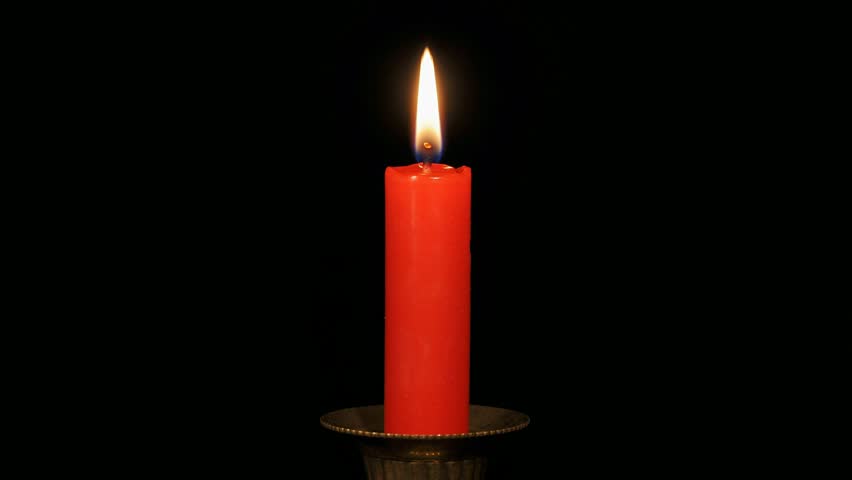 Continuous Loop Of A Burning Red Candle On A Black Background. Stock