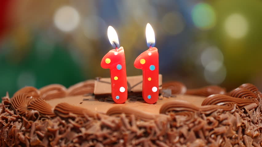 Candles On A Cake Are Blown Out For A 11th Birthday Eleven Years Old