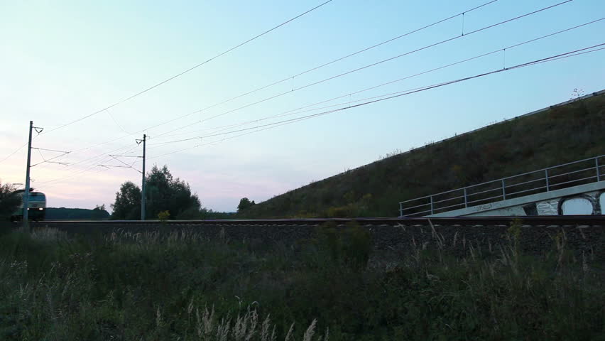 Fast train passing by on a dark evening or night - HD stock footage clip