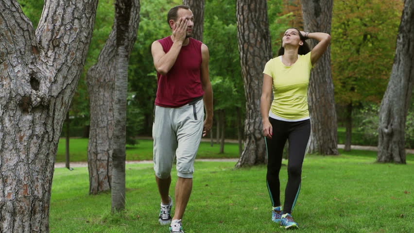 Tired People After Run Walking In The Park Slow Motion Shot Steadycam