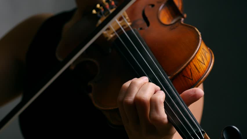 Woman Playing Violin Over Dark Background. 4K, UHD Stock Footage Video