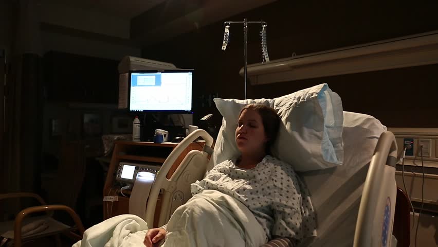 A Pregnant Woman In Labor At The Hospital On A Bed With Nurses In The Room Stock Footage Video 