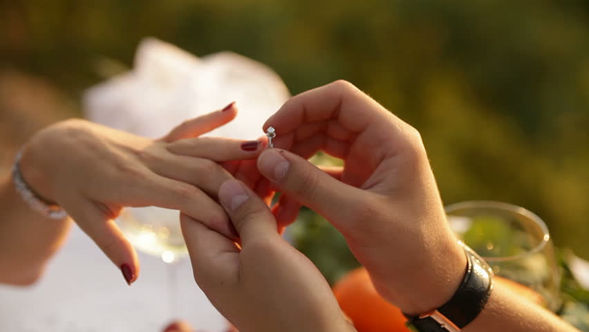 guy-wears-a-ring-on-the-finger-of-a-girl-stock-footage-video-8860357