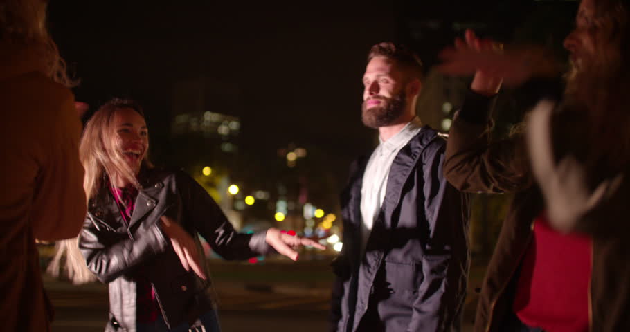 A Group Of Friends Hang Out On A Rooftop Bar At Night And Dance Around ...