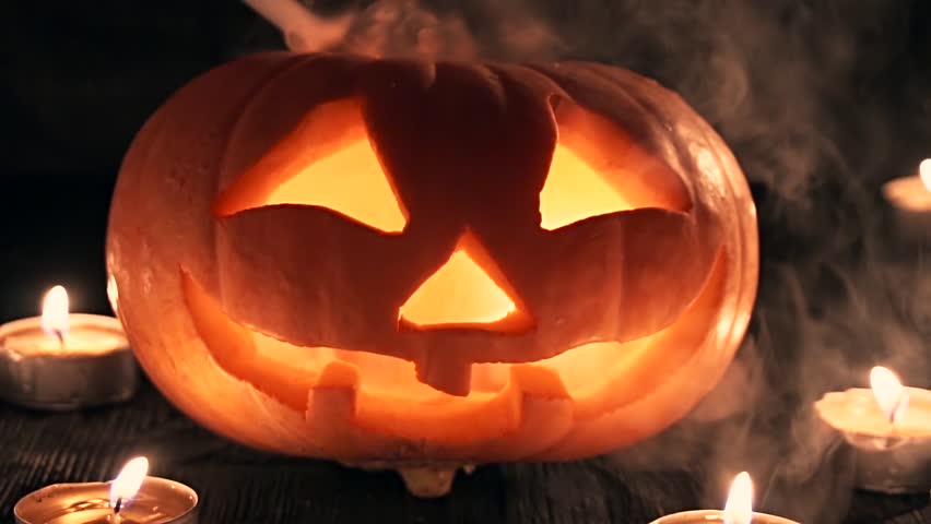 Carved Halloween Pumpkin Lights Inside With Flame On A Black Background ...