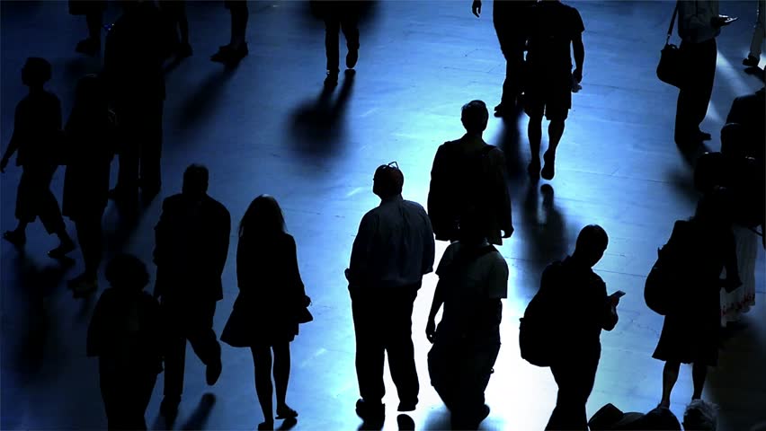 Silhouettes Of A Crowd Of People Walking On A Reflective Surface Past A ...