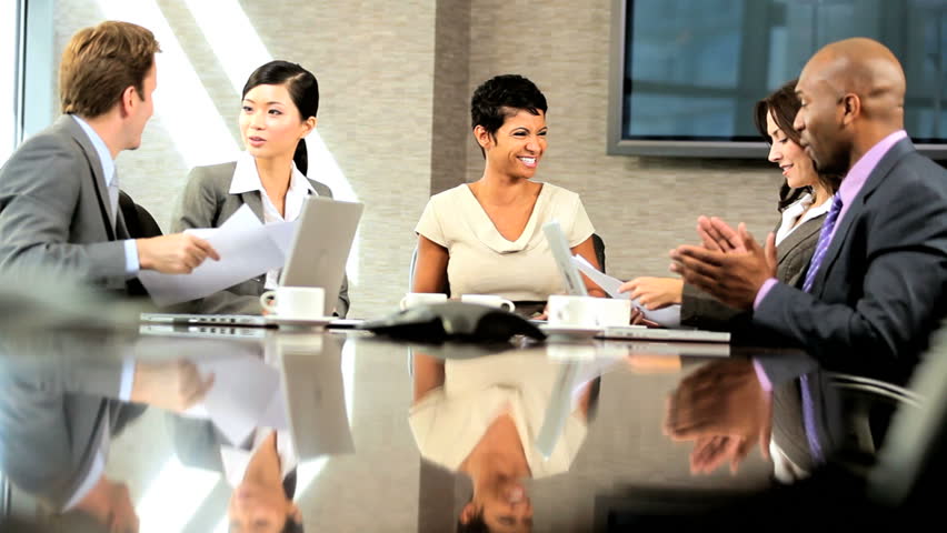 Diverse Group Of Business People In A Boardroom Meeting, Seated Around ...