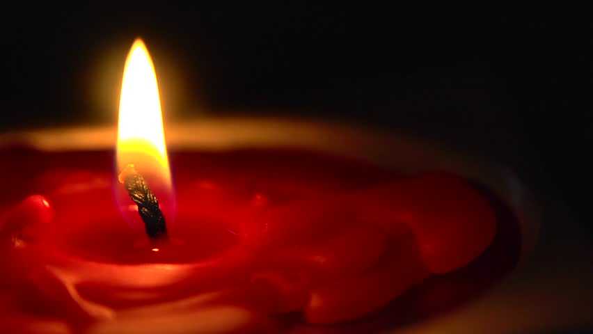 Closeup Of A Candle Flame Being Blown To The Left By The Wind. There ...