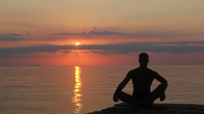 Meditation Near The Sea & Doing Yoga On A Beach At Sunrise Stock ...