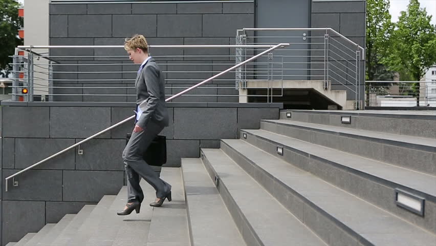 Young Business Woman Walking Upstairs With Smartphone In Slow Motion ...