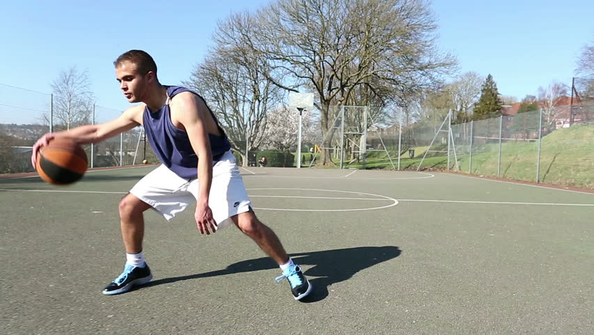 Basketball Player Bouncing The Ball And Scoring A Basket From A Jump ...